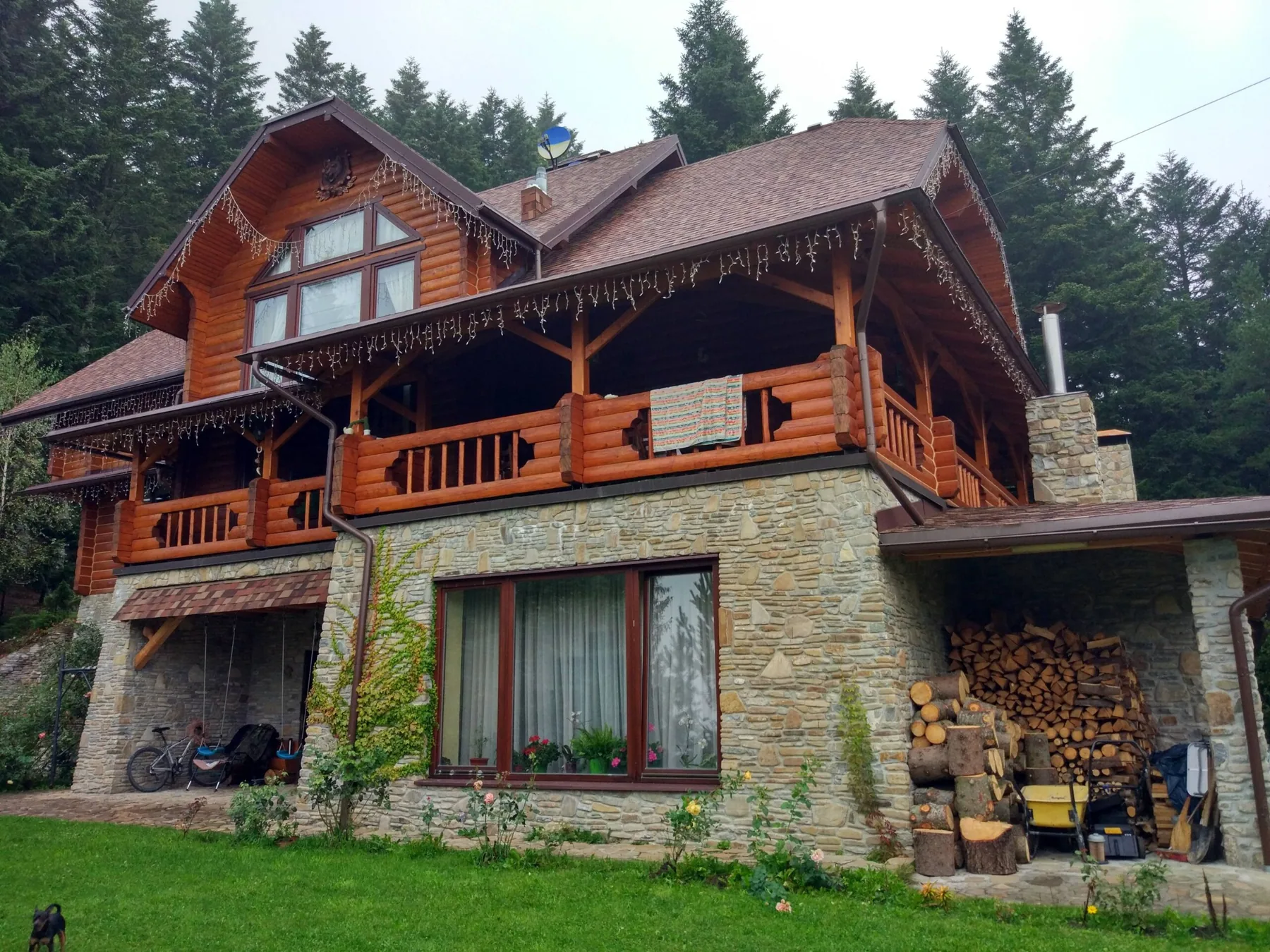 Large log residence with terraces and a stone lower level